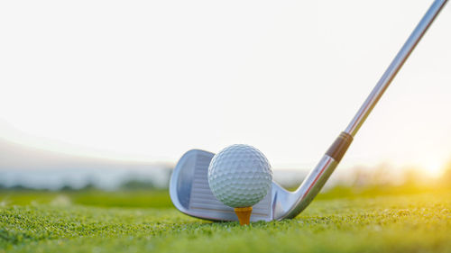 Low section of person playing golf ball