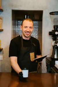 Portrait of a smiling young man in restaurant