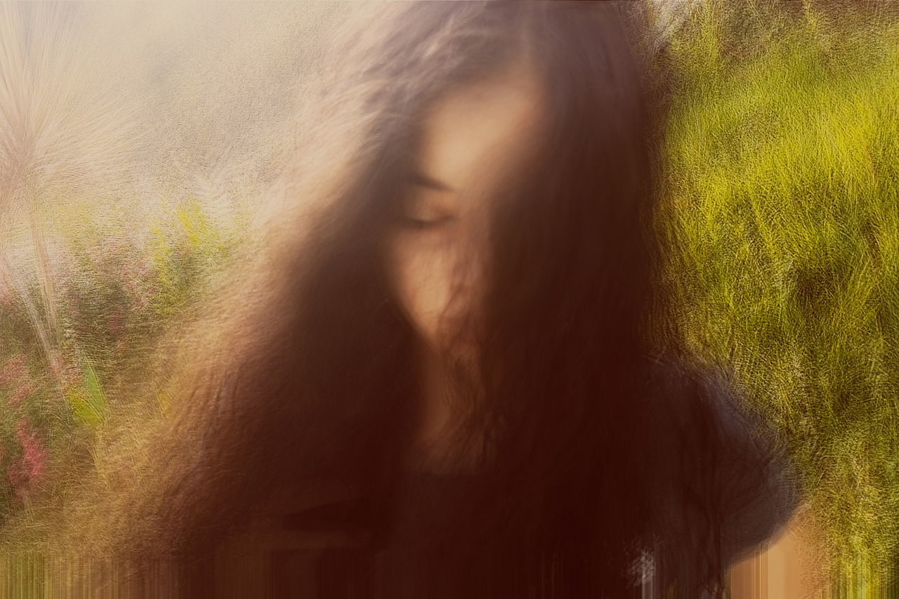 one person, long hair, hair, real people, hairstyle, lifestyles, women, young women, portrait, young adult, leisure activity, day, adult, sunlight, brown hair, headshot, nature, plant, beautiful woman, human hair, human face, obscured face, straight hair