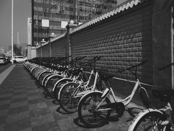Bicycle parked by wall in city