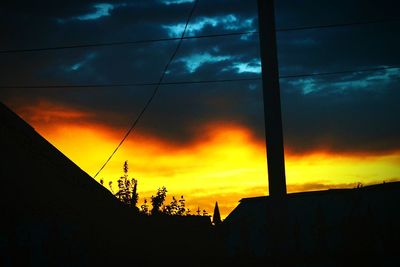 Silhouette of building against dramatic sky