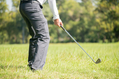 Low section of man playing golf