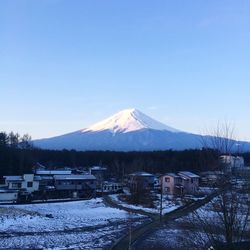 Scenic view of snowcapped mountains against clear sky during winter