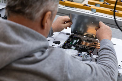 Midsection of engineer working at factory