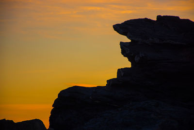 Silhouette of rock at seaside