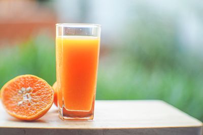 Close-up of orange juice on table