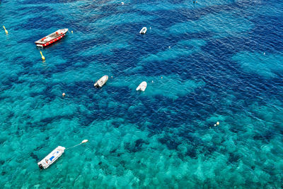 Boats on the seashore in a crystalline sea