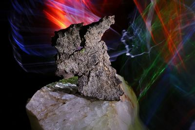 Close-up of bonfire on rock at night