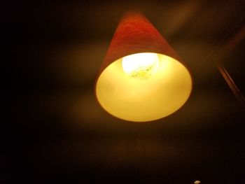 Low angle view of illuminated lamp against sky at night