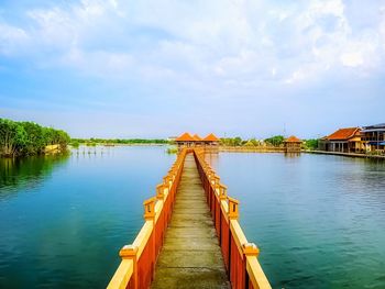 Bridge pier over brackish water against sky  