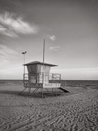 Lifeguard hut on beach against sky