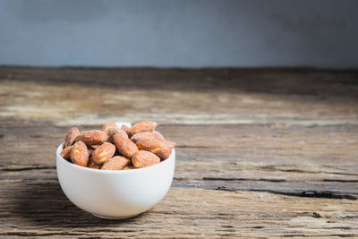 Close-up of salted almonds in bowl on table