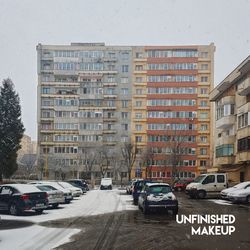 Cars on road by buildings in city