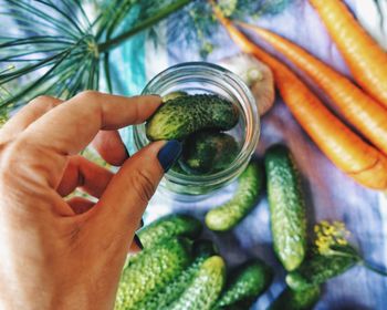 Close-up of cropped hand making pickles