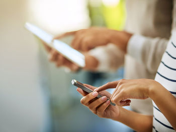 Midsection of woman using mobile phone