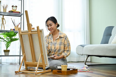 Young woman using laptop at home