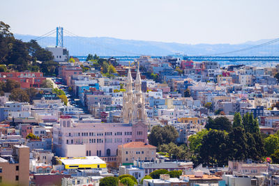 Buildings in city against clear sky