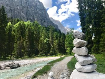 Stack of rocks on mountain against sky