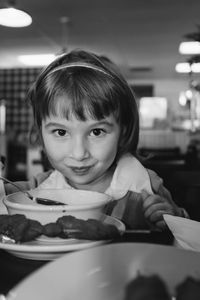 Portrait of girl having food at restaurant