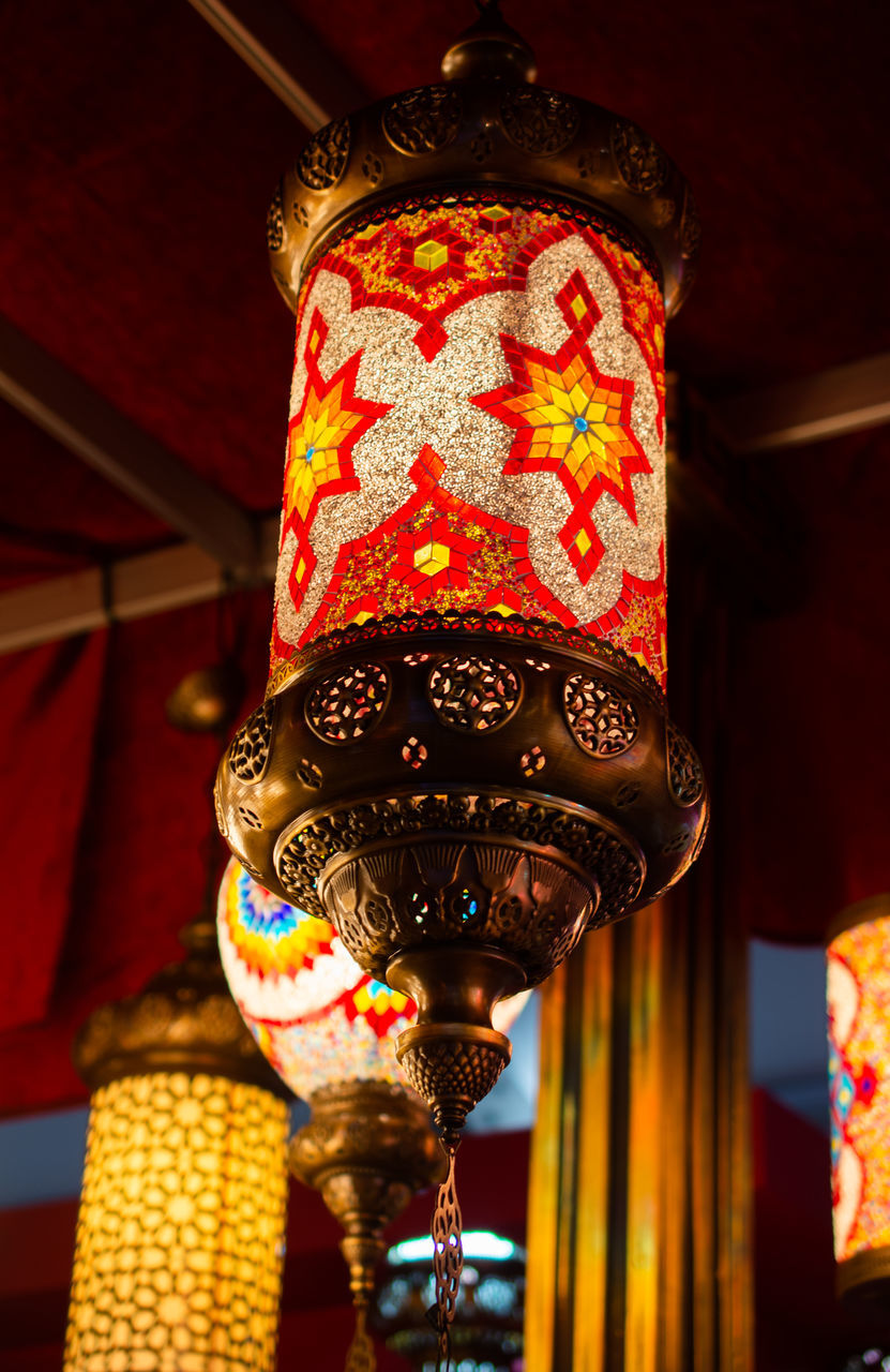 LOW ANGLE VIEW OF ILLUMINATED LANTERN HANGING IN CEILING