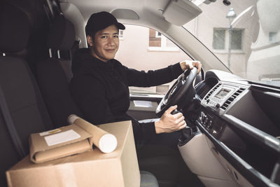 Portrait of man sitting in car