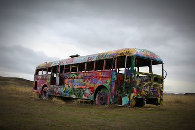 Abandoned truck on field against sky