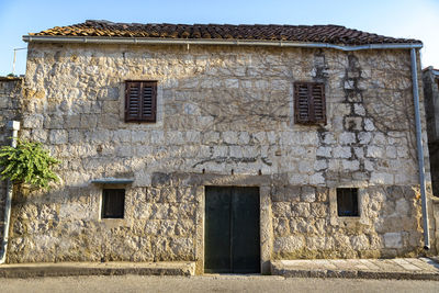 Close-up of abandoned house against sky