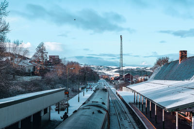 High angle view of snow covered buildings in city