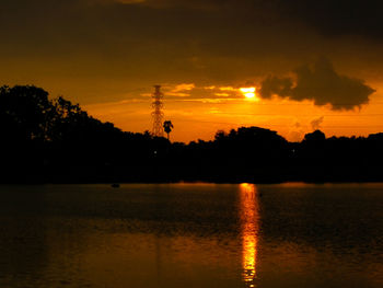 Scenic view of lake against orange sky