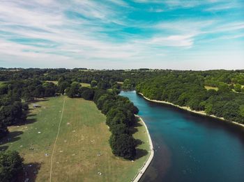 High angle view of river amidst trees against sky