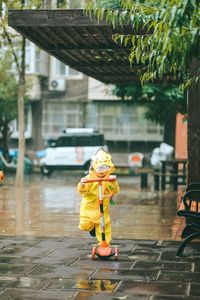 Person with umbrella on wet street during rainy season
