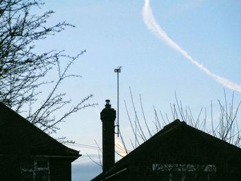 Low angle view of silhouette buildings against sky