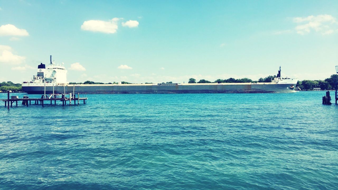 water, sea, sky, blue, built structure, tranquil scene, tranquility, scenics, pier, beauty in nature, cloud, cloud - sky, nature, rippled, idyllic, day, outdoors, calm, ocean, no people, remote, travel destinations, non-urban scene, tourism, cloudy