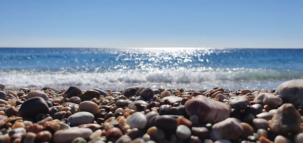 View of pebbles on beach against sky