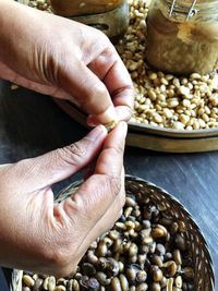 High angle view of person preparing coffe beans