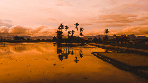 Scenic view of lake against sky during sunset