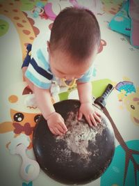 Midsection of child on table at home