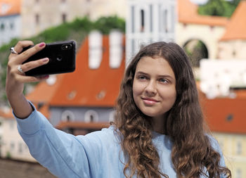 Portrait of beautiful young girl using mobile phone