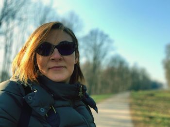 Portrait of woman wearing sunglasses against sky