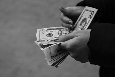 Cropped hand of man holding paper currency