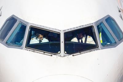 Low angle view of people on glass window