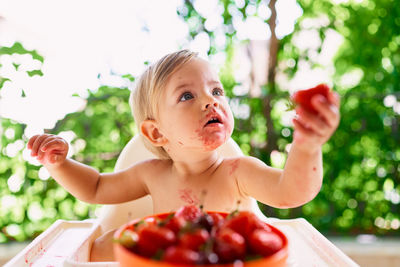 Portrait of cute girl holding fruits