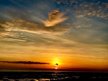 Scenic view of dramatic sky over sea during sunset