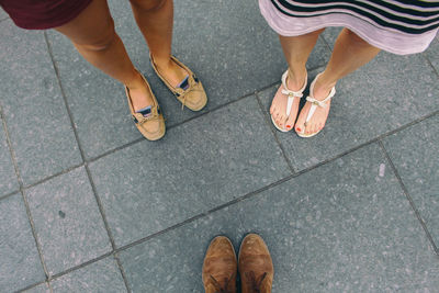 Low section of people standing on footpath