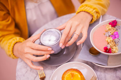 High angle view of woman holding ice cream