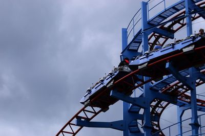 Low angle view of crane against sky