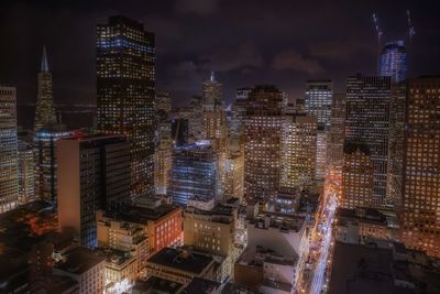 Aerial view of city lit up at night