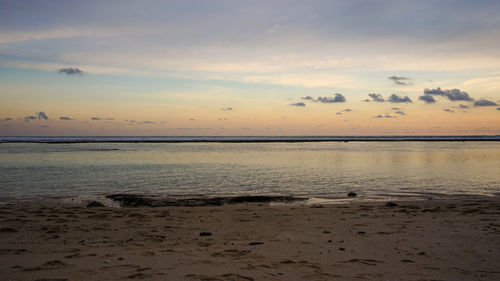 Scenic view of beach against sky during sunset