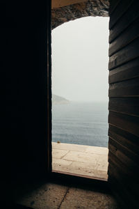 View of sea seen through window