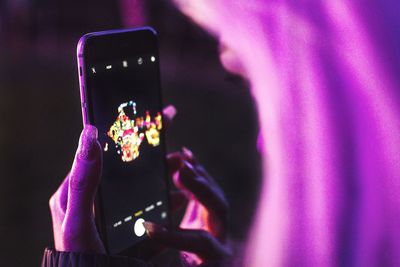 Midsection of woman photographing with mobile phone